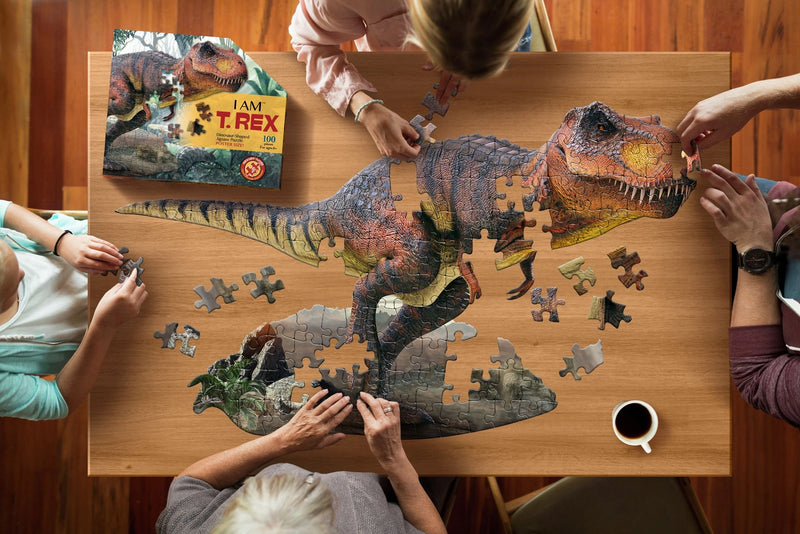 Family assembling a dinosaur puzzle on a wooden table