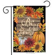 Decorative garden flag with autumnal design featuring sunflowers, pumpkins, and the text 'Be Grateful'.