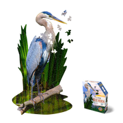 Jigsaw puzzle of a blue heron with greenery and packaging on a white background
