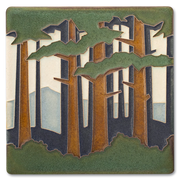 Decorative tile with a forest design featuring trees and mountains.