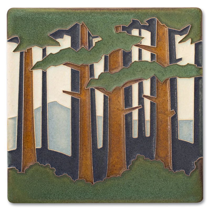 Decorative tile with a forest design featuring trees and mountains.