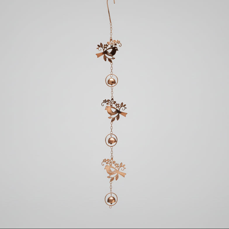 Triple Birds Flamed Ornament hanging on a tree branch