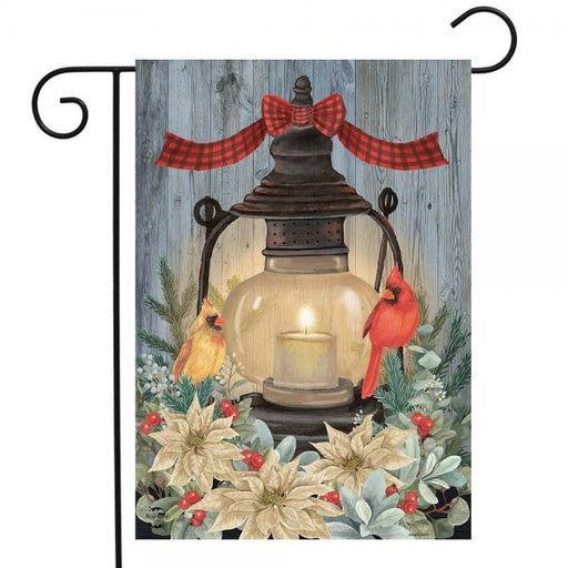 Decorative flag with a lantern, cardinal birds, and flowers on a wooden background
