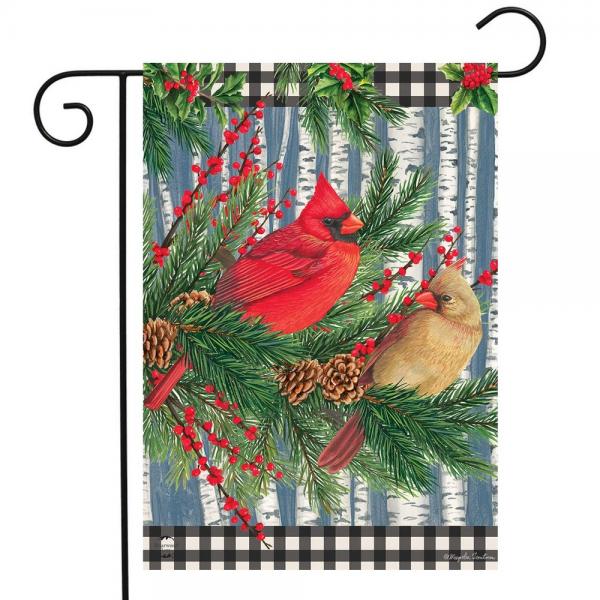 pair of cardinals perched in sprigs of evergreen, some pinecones and berries. Background is birch trees with and black and white checkered bordered top & bottom