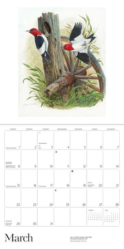 Calendar page with illustration of two redheaded woodpeckers on a tree stump and wagon wheel, with March text.