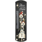 bless our home thermometer with black backgrouynd featuring stacked white birdhouses, a cardinal and a goldfinch. 