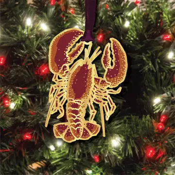 Decorative lobster ornament on a holiday tree with lights.