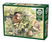 Cobble Hill puzzle box with birds and a nest on a green background