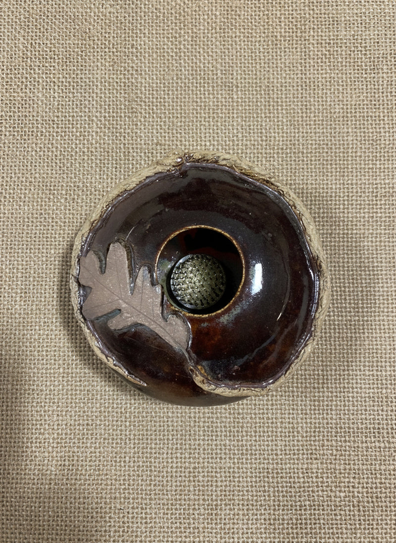 Brown ceramic bowl with oak leaf and the flower frog inside