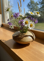 ceramic pillow vase in use with cuttings of wildflowers inside