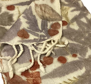 Folded scarf with leaf pattern on a white background