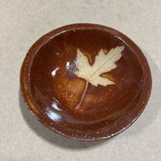 Brown ceramic bowl with a maple leaf 