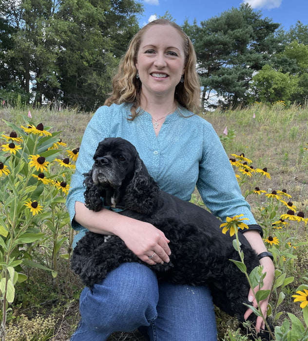 Martha Holzheuer with her cocker spaniel in the store's dry sand prairie