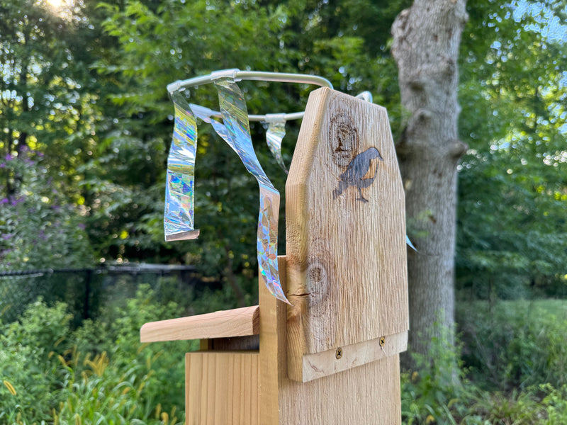 Rear view of Sparrow Chaser installed on an Ultimate Bluebird House showing how the  mounting board can be reversed for nest boxes with extended backboards
