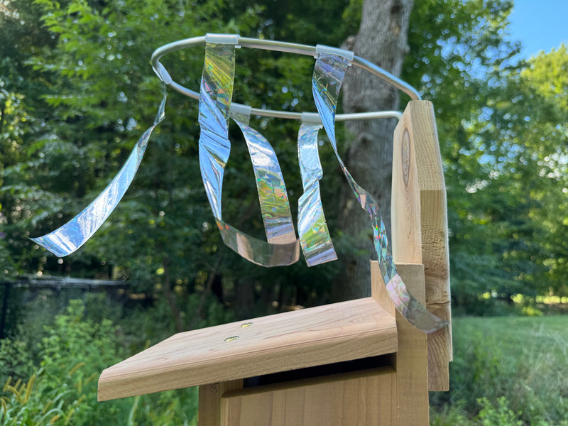 Side view of Sparrow Chaser installed on an Ultimate Bluebird House illustrating how the mylar strips should touch the top of the roof