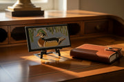 Decorative tile with a wood duck design displayed on a metal easel 