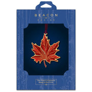 Maple leaf ornament displayed in blue Beacon Design packaging on a white background