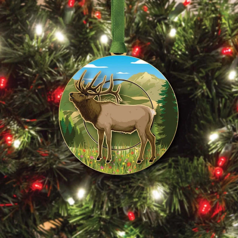 Decorative ornament with a mountain elk design on a Christmas tree.