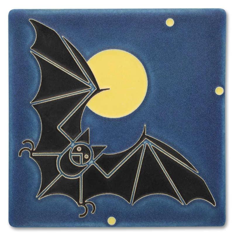 Decorative tile with black bat design against a deep blue background with a full yellow moon.