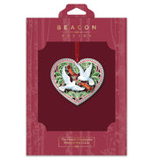 Heart-shaped ornament with doves and Peace on Earth message, on Beacon Design packaging
