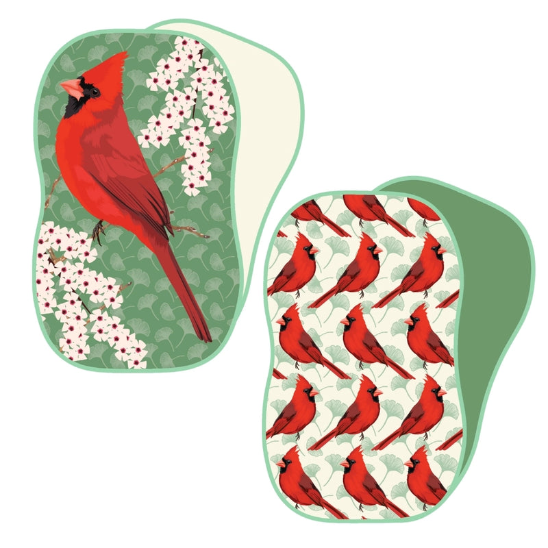 Reusable sponges with red cardinal bird designs on a white background