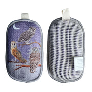 Both sides of reusable kitchen sponges, one with owl illustrations and the other with a cotton mesh.
