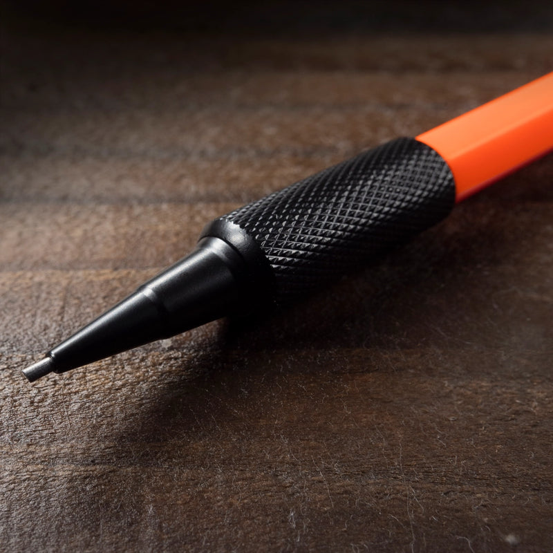 up close of the tip of the orange mechanical pencil and lead 