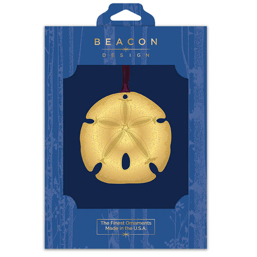 Gold sand dollar ornament in Beacon Design packaging on a white background