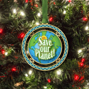 Ornament with 'Save Our Planet' message on a Christmas tree