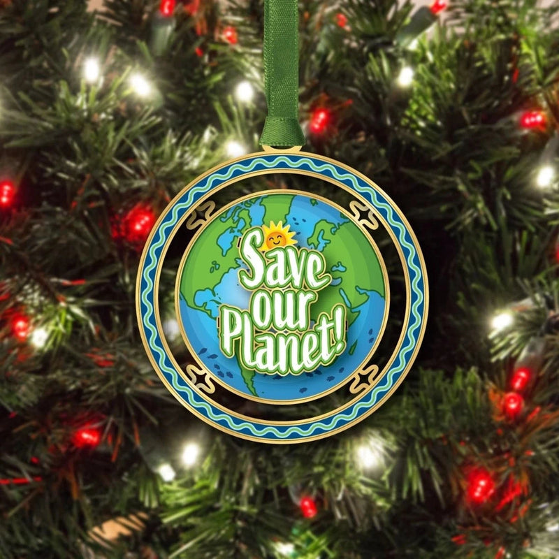 Ornament with 'Save Our Planet' message on a Christmas tree
