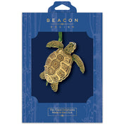 Gold sea turtle ornament in Beacon Design packaging on a white background