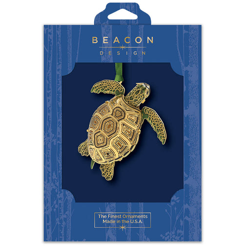 Gold sea turtle ornament in Beacon Design packaging on a white background