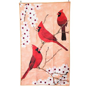 Tea towel with red cardinals and white flowers on a pink background