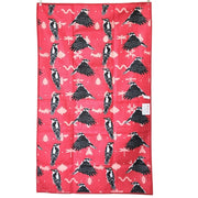 One  side of tea towel featuring black and white woodpecker pattern on a red background 