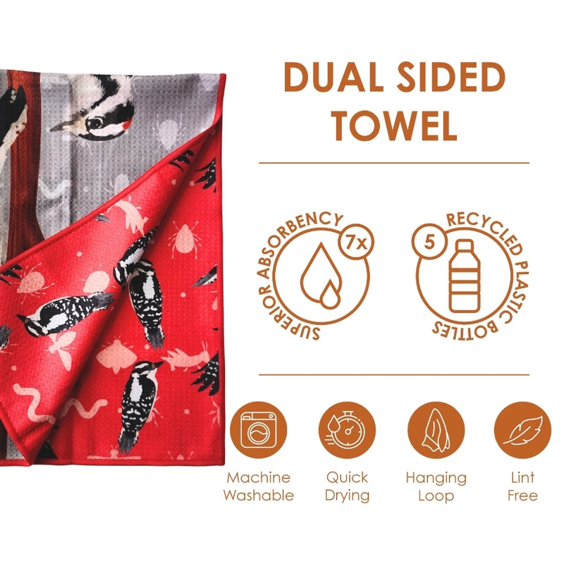 Dual-sided towel with woodpecker design, featuring sustainability icons and text.