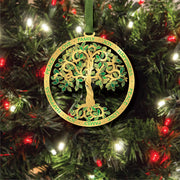 Decorative Tree of Life ornament with a tree design and text on a Christmas tree.
