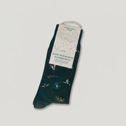 green woodpecker and berries sock with paper packaging on
