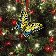 Butterfly ornament on a Christmas tree with lights and.