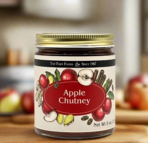 Jar of Apple Chutney with a decorative label on a wooden surface.