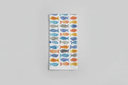 a kitchen towel with fish on it on a gray background