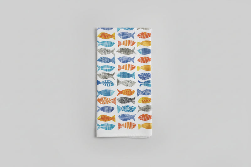 a kitchen towel with fish on it on a gray background