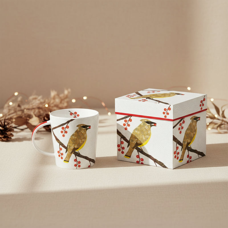 white mug with cedar waxwing perched on branch surrounded by and eating a red berry. bird has patterned design background has gray polka dot design 