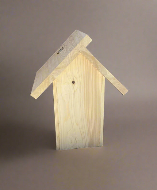 Back of wooden birdhouse with a slanted roof on a neutral background