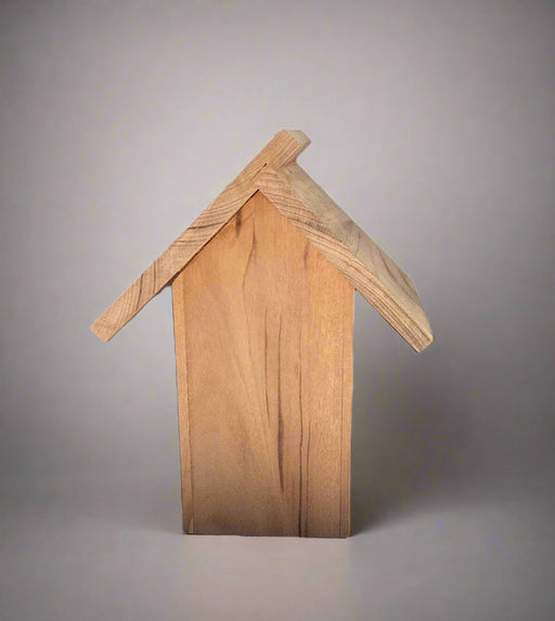 Back of wooden birdhouse with a slanted roof on a gray background