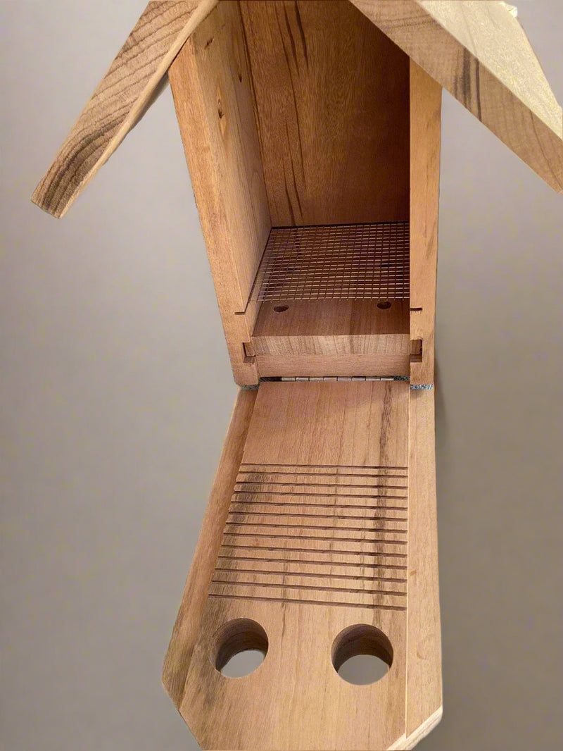 Interior of bluebird nest box with metal nest lift and climbing grooves for fledglings. 