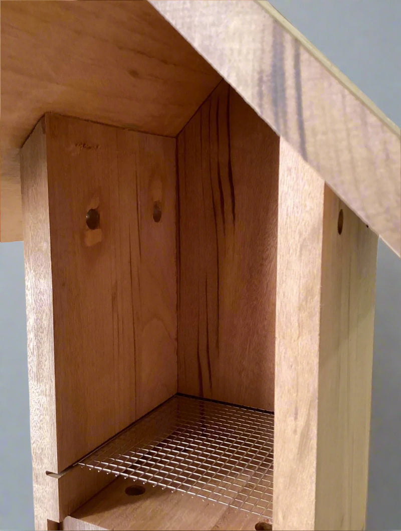Interior of Bluebird nest box showing nest lift and side wall ventilation holes.
