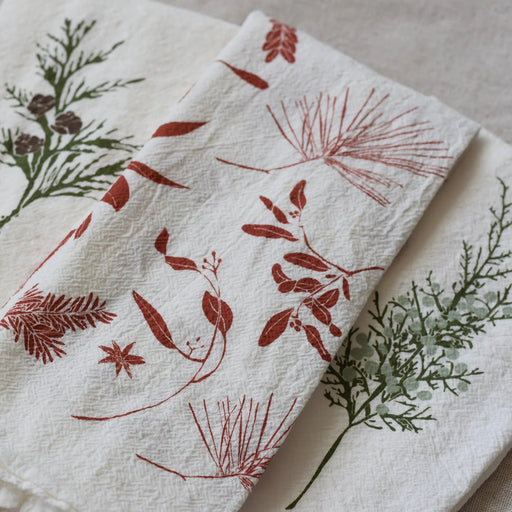 Red Boughs and Berries Napkin Set featured in front of the Winter Greens Napkin Set (sold separately)