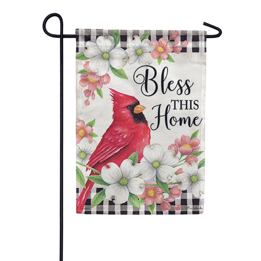 Decorative garden flag with a red cardinal, dogwood flowers, and 'Bless This Home' text on a checkered background.