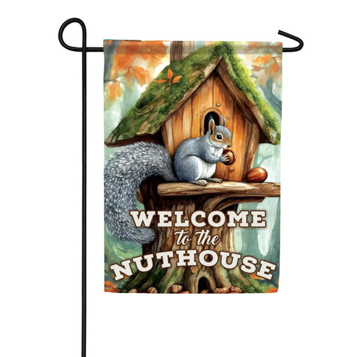 Decorative garden flag with a squirrel and treehouse design, featuring the text 'Welcome to the Nuthouse'.