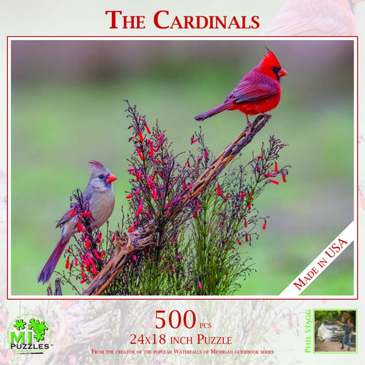 Jigsaw puzzle packaging featuring two cardinals on a branch with flowers, labeled 'The Cardinals'.